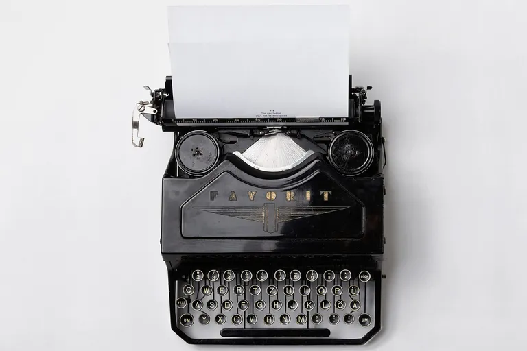 A vintage typewriter in warm window light