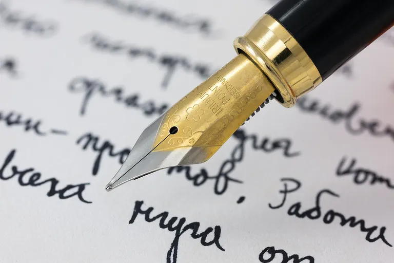 A fountain pen writing on a sheet of paper
